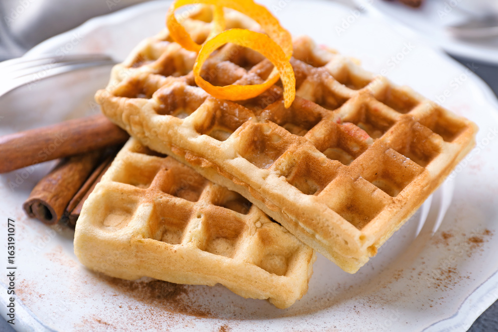 Delicious cinnamon waffles with orange zest, closeup Delicious cinnamon waffles with orange zest, closeup