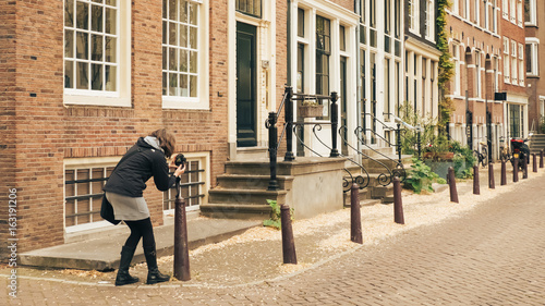 AMSTERDAM, HOLLAND - May 10 2017: woman photographer on the street.