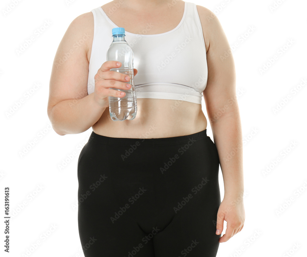 Overweight young woman with bottle of water on white background. Diet concept Overweight young woman with bottle of water on white background. Diet concept