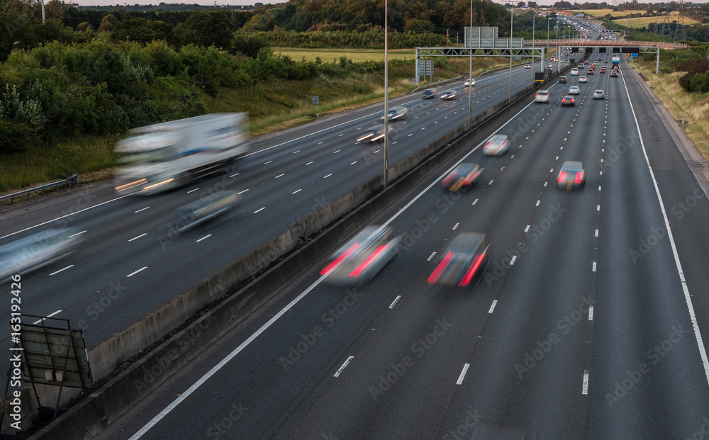 Traffic on the motorway at the dusk time