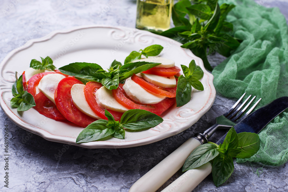 Italian caprese salad with mozzarella, tomatoes and basil Italian caprese salad with mozzarella, tomatoes and basil