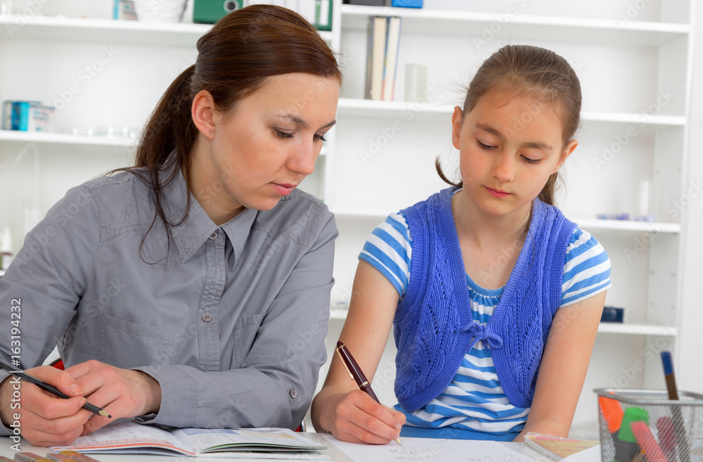 Fototapeta premium Mother Helping Daughter With Homework
