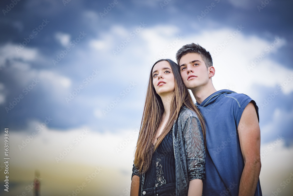 Romantic young teenage couple in love hugging, enjoying a sunny day outside Romantic young teenage couple in love hugging, enjoying a sunny day outside