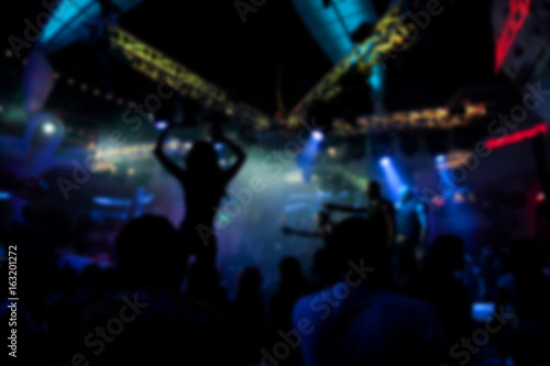 Blurry night club dj party people enjoy of music dancing sound with colorful light. club night light dj party Ibiza club. With Smoke Machine and lights. Dark background. © Alexey Lesik