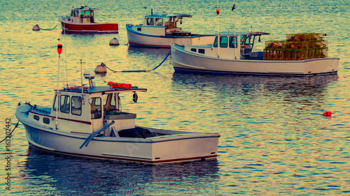 Lobster boats moored in the Sheepscot River at the Wiscasset Waterfront at sunset photo