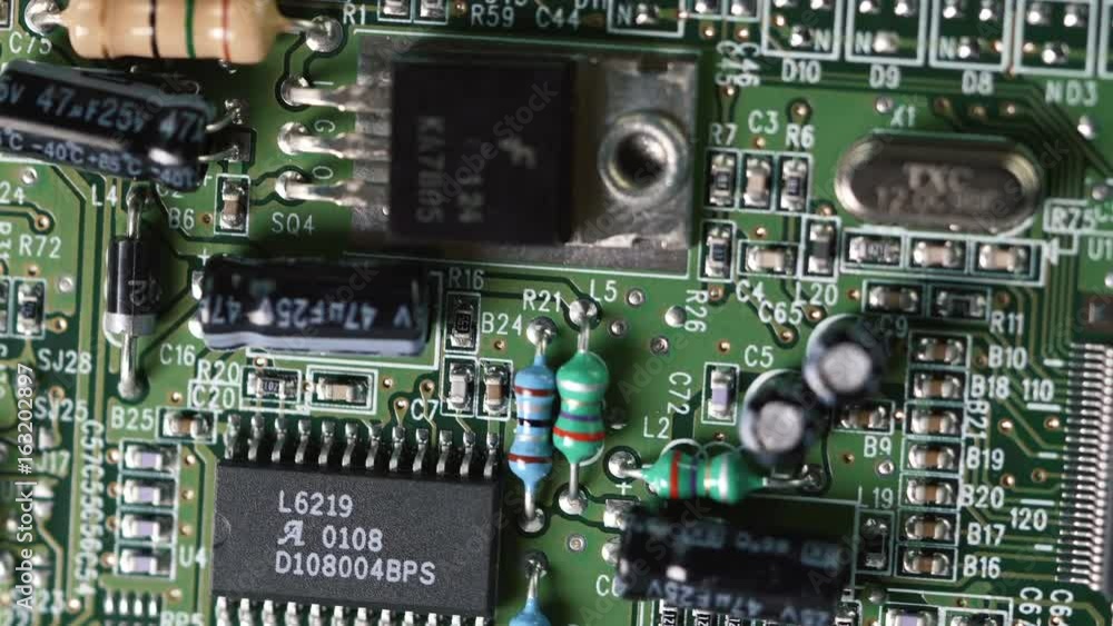 Macro shot of technology background. Electronic circuit chips on PC board rotating. Shallow depth of field. Macro shot of technology background. Electronic circuit chips on PC board rotating. Shallow depth of field.