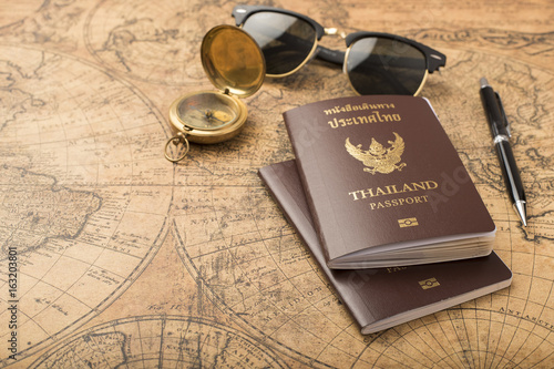 Planning travel concept, Thailand passport on old map photo