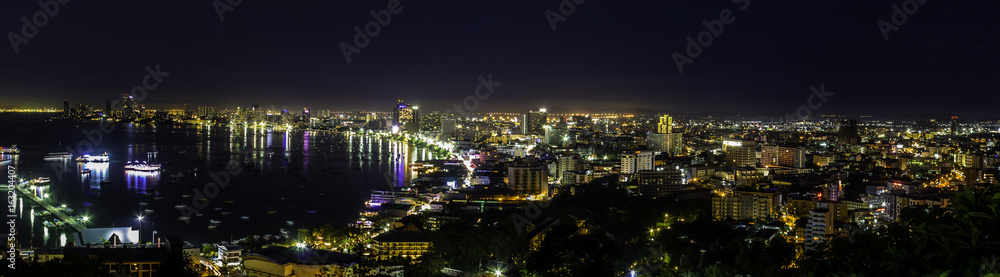 Fototapeta premium Beautiful Pattaya Bay at night./ Panorama colorful landscape gulf and city Pattaya at night on summer day in Thailand. 