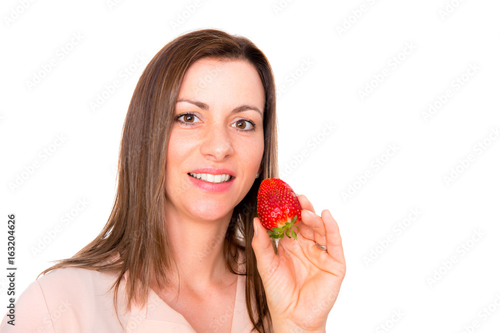 young woman eating srawberry looking surprised young woman eating srawberry looking surprised