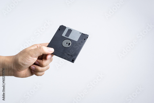 Hand holding floppy disk