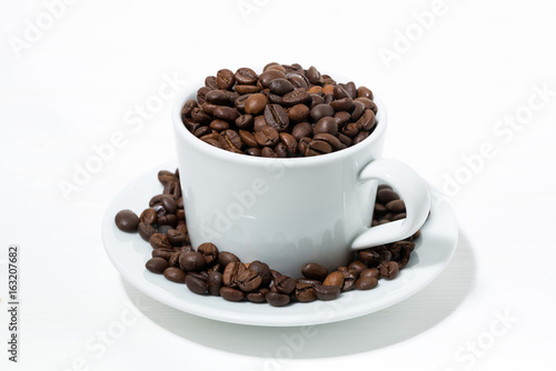 cup with coffee beans on white background  closeup