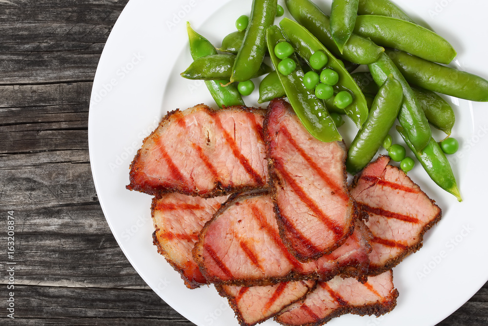 grilled slices of meat and green pea
