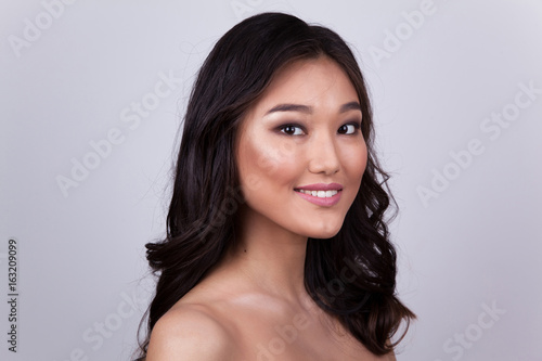 Portrait of a beautiful asian woman with naked shoulders. photo