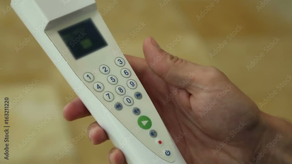 Tourist choosing settings on control panel of audio guide by pressing buttons