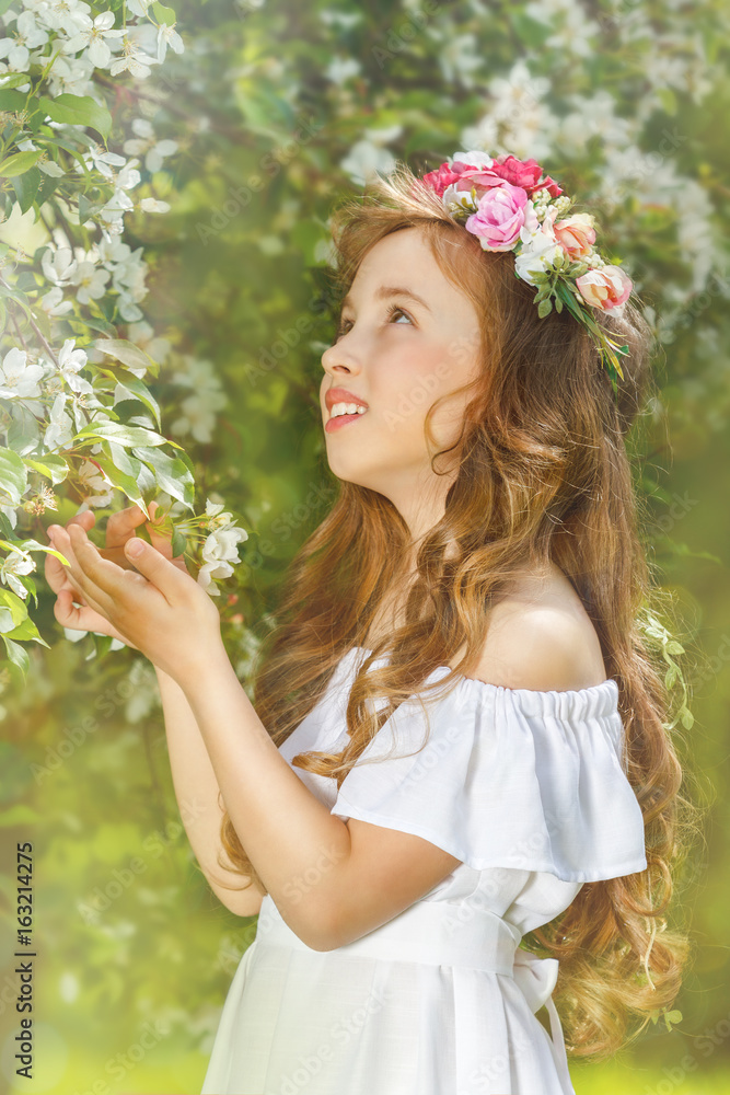 Charming girl in a blooming Apple orchard on a Sunny spring day Charming girl in a blooming Apple orchard on a Sunny spring day