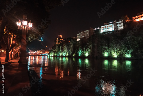 Evening view of Tbilisi and the Kura river at dusk photo