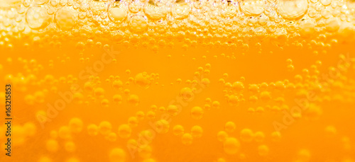 bubble beer close up / yellow background / water / drink