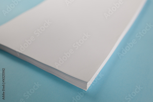 Blank Office Paper A4 Mock-Up on blue background. Close up
