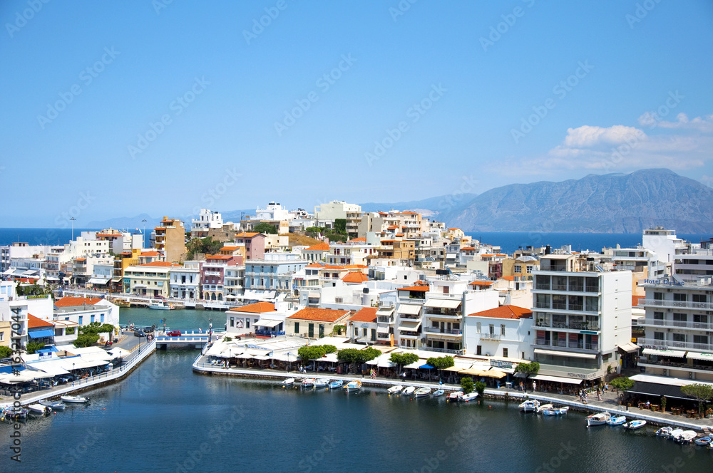View of Lake Voulismeni in Agios Nikolaos, Crete, Greece. A beautiful coastal city with colorful buildings.