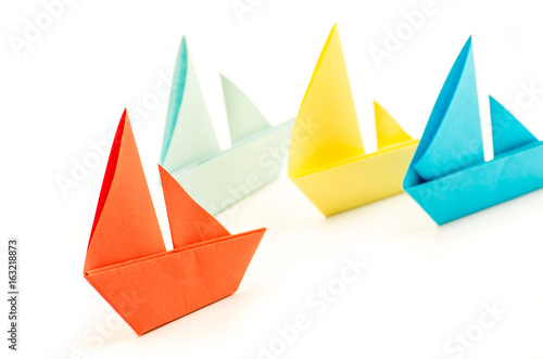colorful paper origami boats or ships leadership