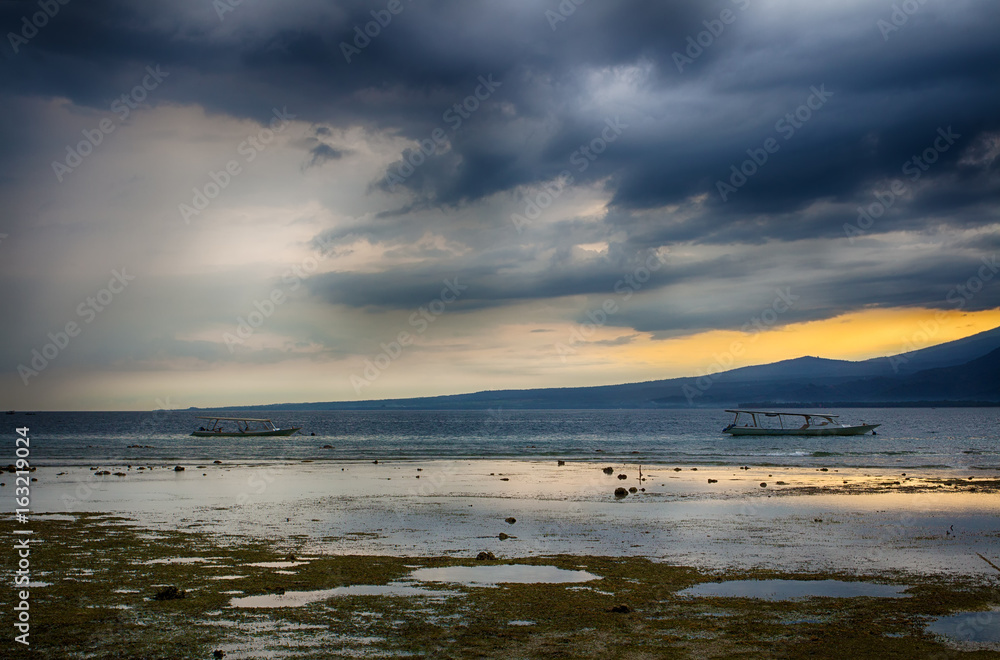 Dark sky over the ocean, the Small island of GILI Indonesia. Of the Indian ocean.