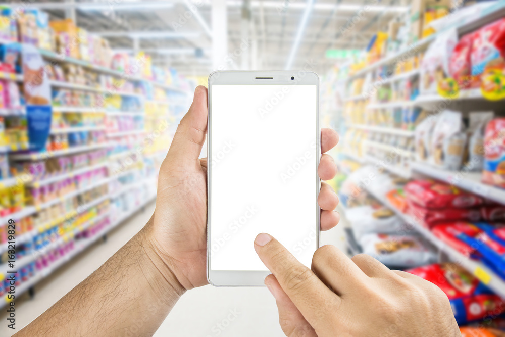 Hand holding Using smart phone in supermarket. Hand holding Using smart phone in supermarket.