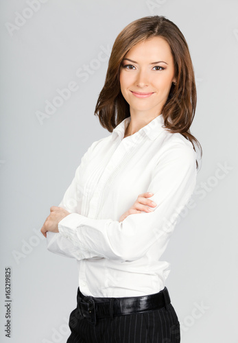 Happy smiling business woman, over grey