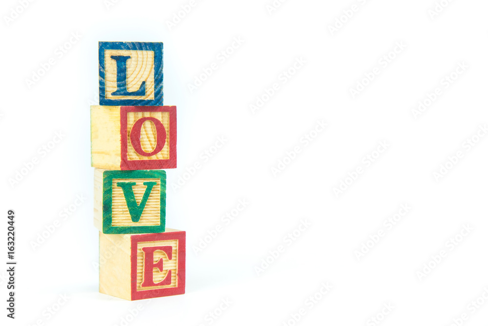 wooden toy cubes are used to create the word love,Love concept or valentine day. wooden toy cubes are used to create the word love,Love concept or valentine day.
