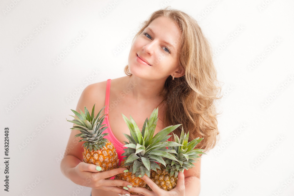 Young beautiful girl posing with fresh pineapple.Summer concept. Young beautiful girl posing with fresh pineapple.Summer concept.