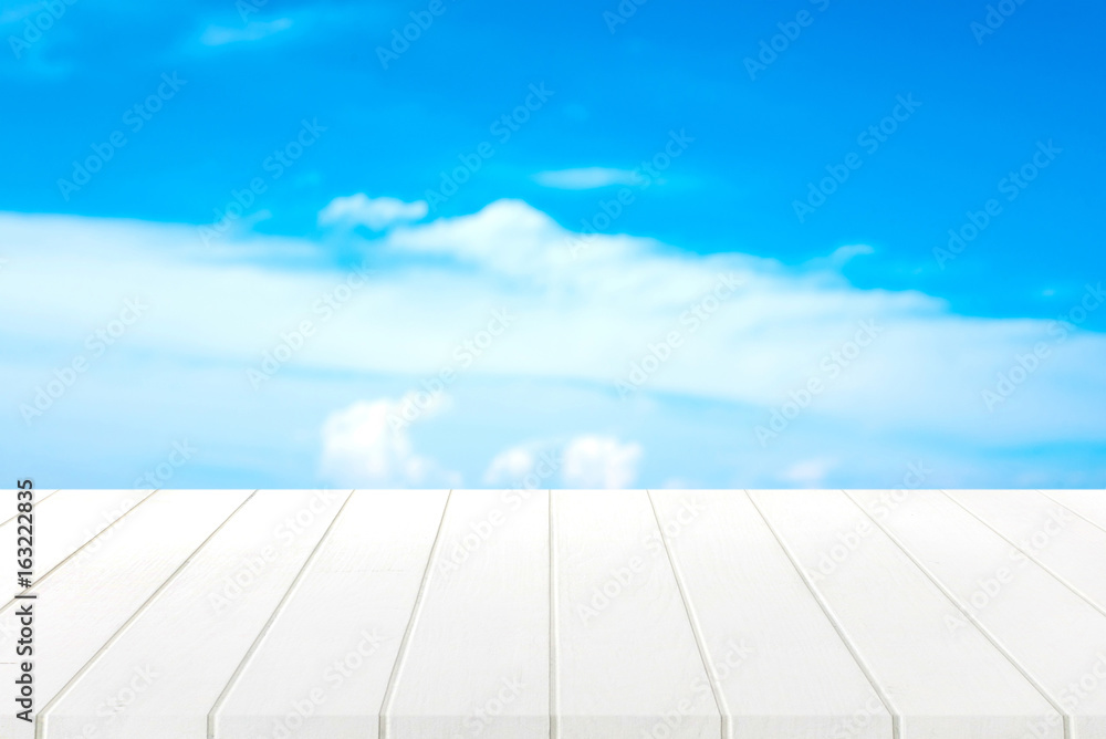 white wood table and blue sky background. white wood table and blue sky background.