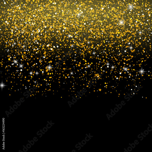 Golden glitter particles background on black background.