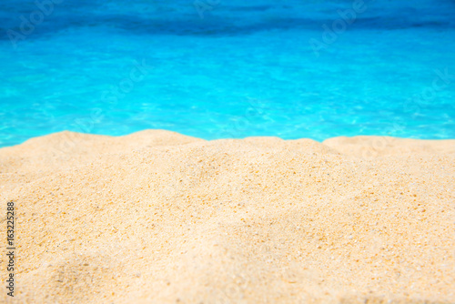 Sand beach and tropical blue sea.