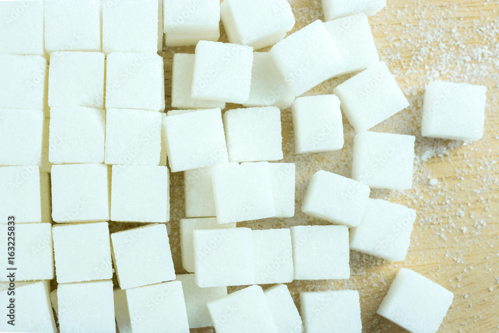 close up of white sugar cubes on wooden table. close up of white sugar cubes on wooden table.