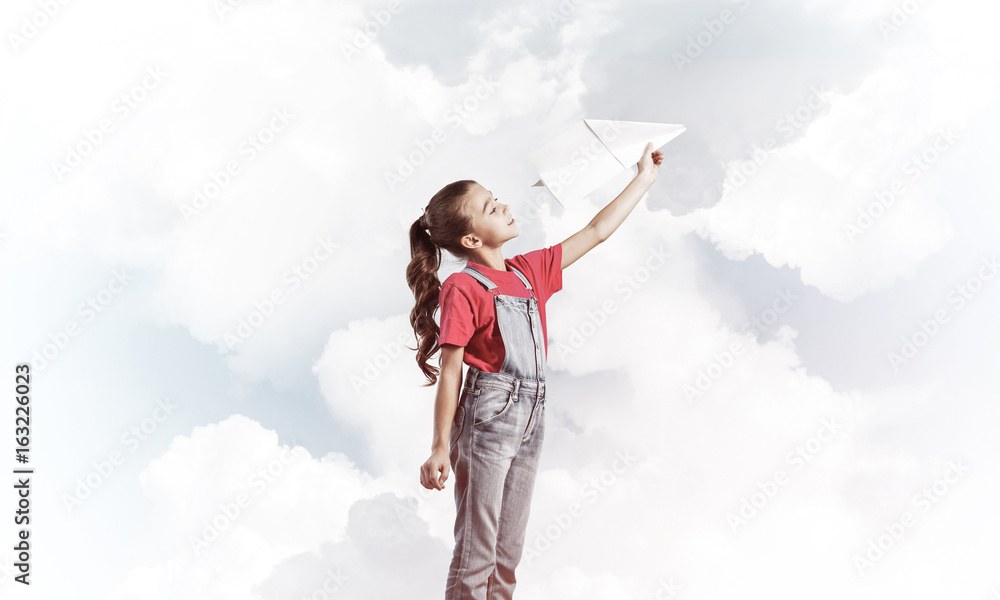 Concept of careless happy childhood with girl dreaming to become Concept of careless happy childhood with girl dreaming to become