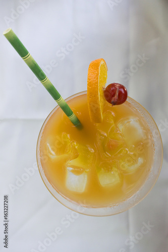 Tropical cocktail with orange and cherry garnish