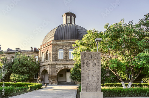 Building of the Gevorgyan Spiritual Academy with the ancient khachkar in the park in Etchmiadzin

