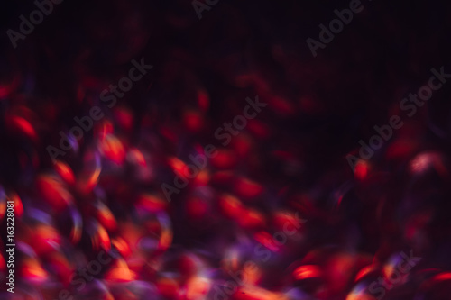 Abstract blurred glittering shine, blue and red. Blur light bokeh, night background. Christmas wallpaper decorations concept. New year holiday festive backdrop. Sparkle circle celebrations display.