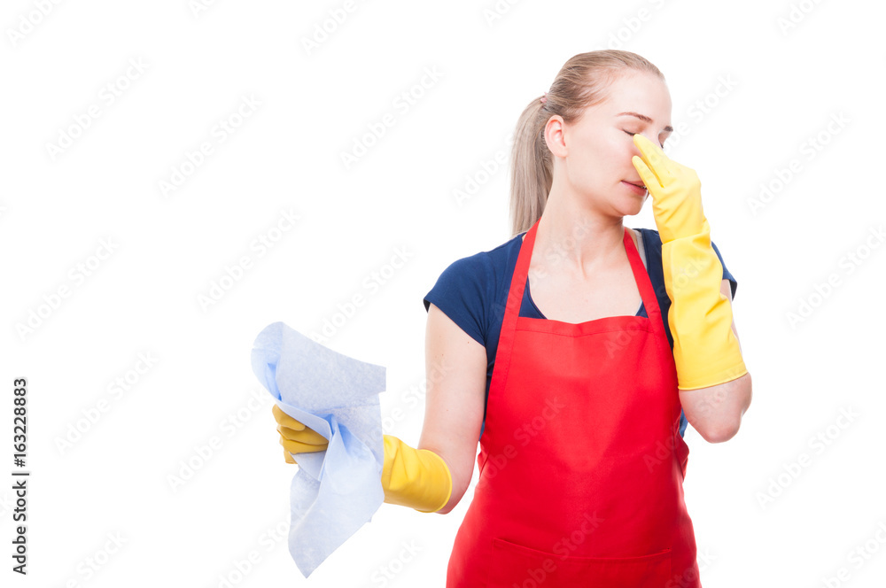 Disgusted woman holds dirty rag and pinching nose Disgusted woman holds dirty rag and pinching nose