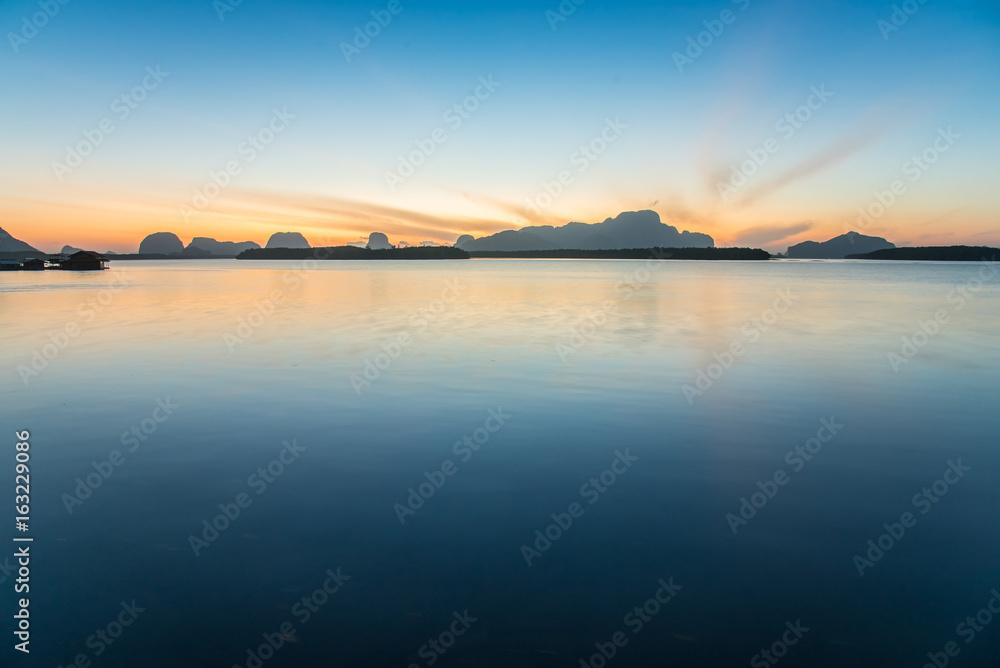 Fototapeta premium Calm sea and beautiful sunrise at BanSamChongTai, in Phang-nga province, Thailand.