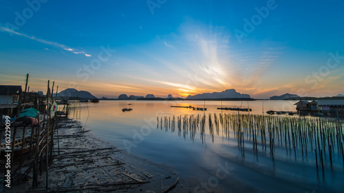 Calm sea and beautiful sunrise at BanSamChongTai, in Phang-nga province, Thailand. © satit