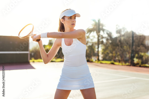 Beautiful woman playing tennis match © Jacob Lund