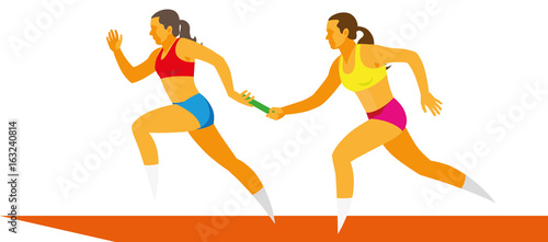 Young woman sprinter passes the baton to her relay race partner
