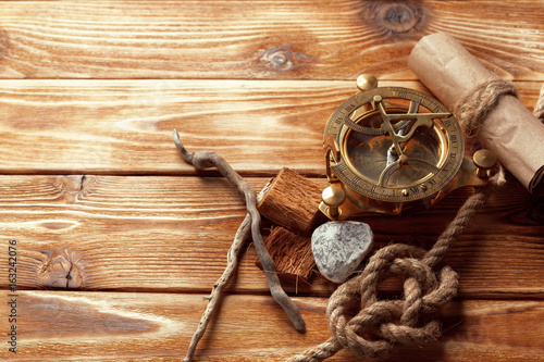 compass and rope on old wooden boards
