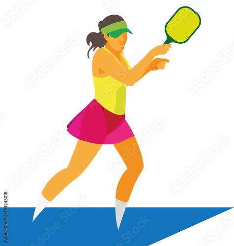 Young woman in baseball cap playing pikleball