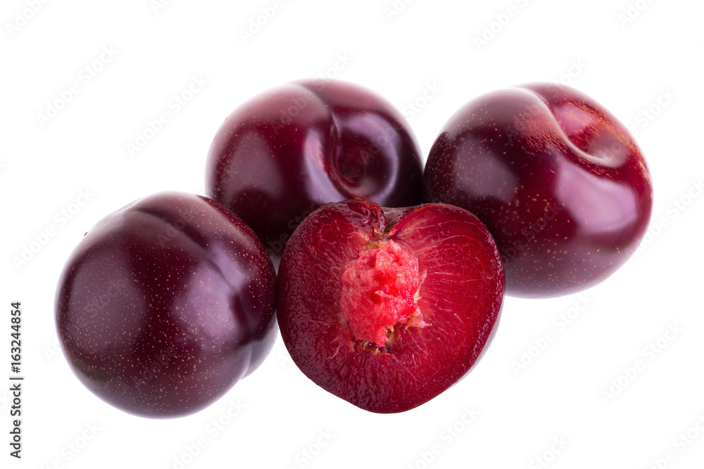 ripe fresh plum with half and slice isolated on white background
