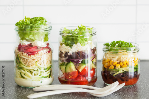 healthy vegetable and cheese salad in mason jars