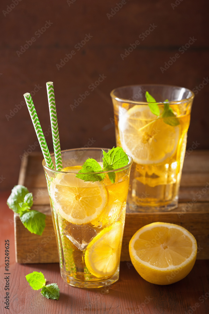 ice tea with lemon and mint on dark rustic background ice tea with lemon and mint on dark rustic background