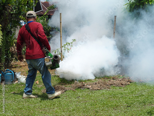 Men are working fogging to eliminate mosquitoes.