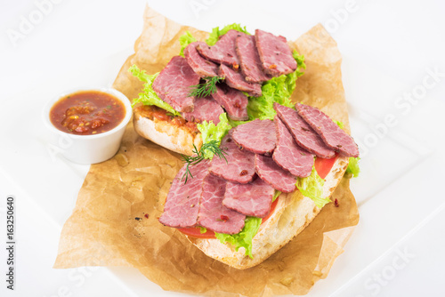 Bruschetta with beef on a plate on a white background.