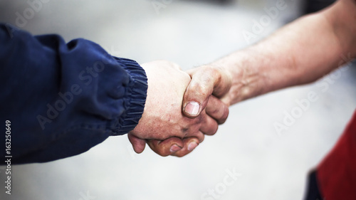 Handshaking of Two Workers © krsmanovic